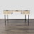 This West Elm desk features a modern design with a white frame, natural wood textured drawer fronts, and sturdy black...