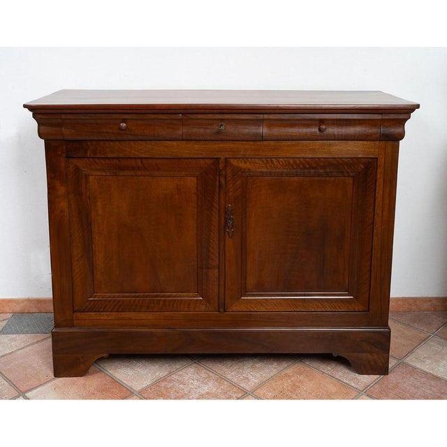 Antique Provençal sideboard with a hooded top, crafted from solid walnut, dating from the Louis-Philippe period in the...