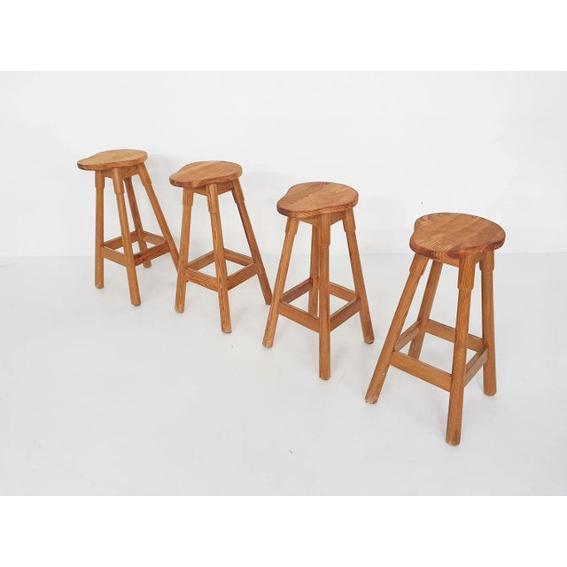 Set of four pinewood bar stools.Traces of use consistent with age and use.