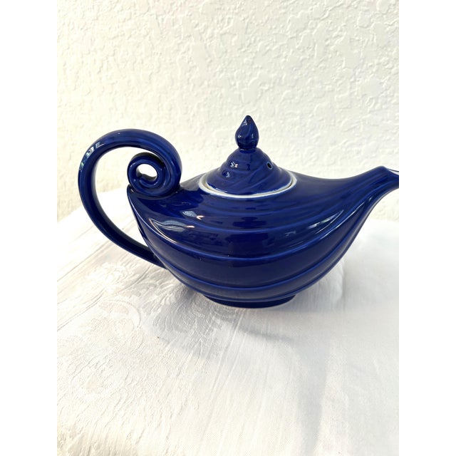 Charming Hall ceramic "Aladdin" genie design lidded teapot in a shade of Cobalt blue with white interior. Holds 48 ounces.