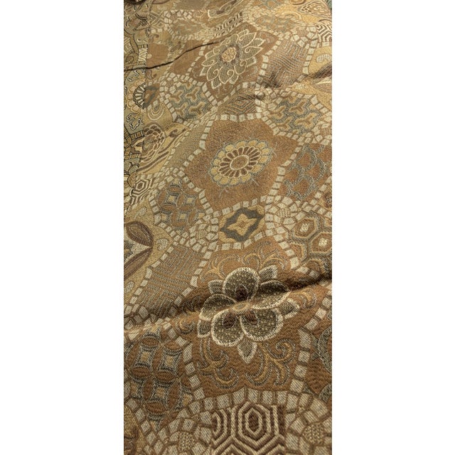 This is a lovely brocade textile in shades of brown and gold. There is an interesting floral/geometric pattern. There is...