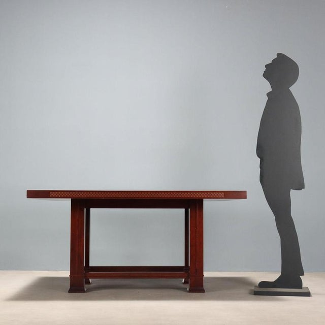 Elegant cherry wood dining table with carved legs and a rectangular top. In good overall condition with some signs of...