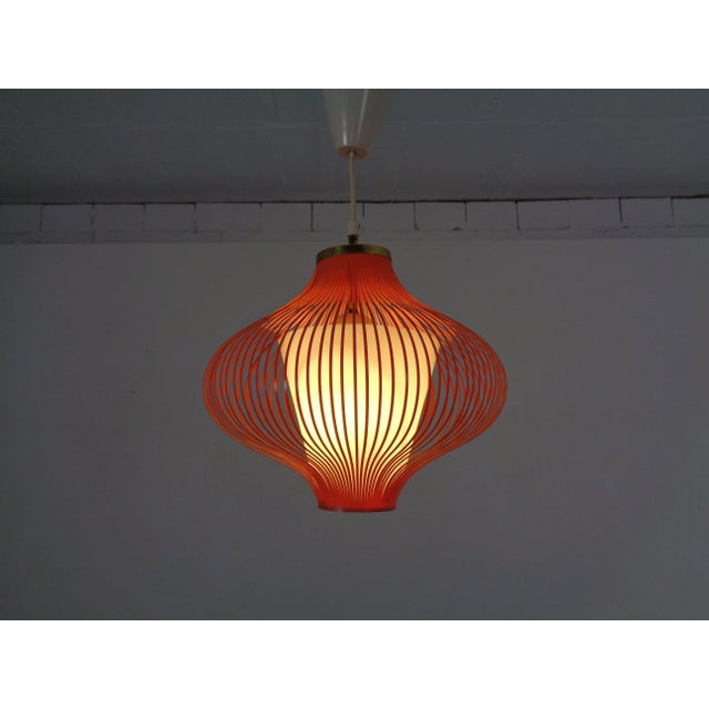 A pair of delicate spaghetti-style ceiling lamps in mint and apricot from the 1950s. Made of plastic and brass. European...