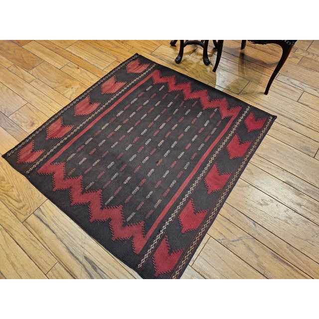 This exceptionally rare early 20th-century Persian Baluch Tribal Sofreh Kilim is a highly collectible piece of authentic...