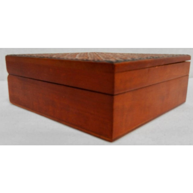 Tiny details have been carved in the top of this small wooden box from Poland. The outside of the box has been stained and...