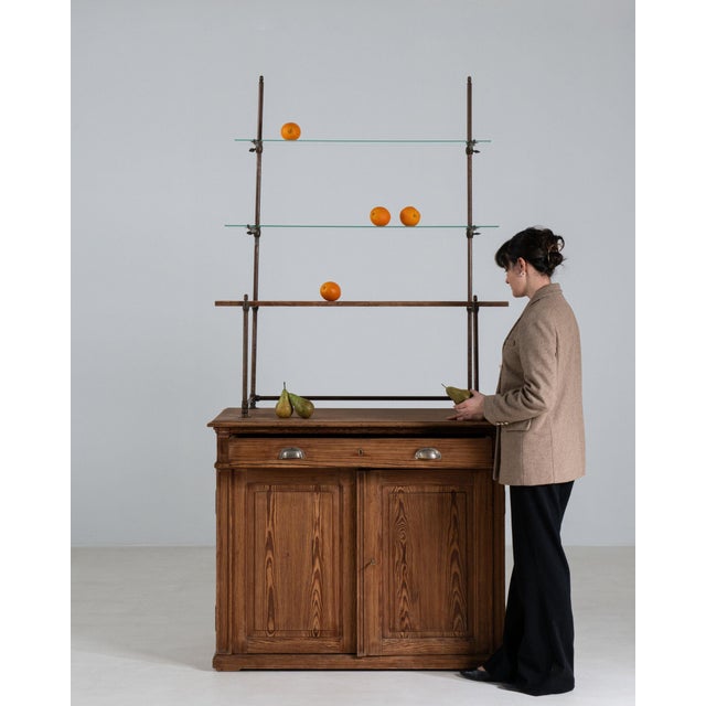 Here is a bar cabinet/etagere, its dark oak, glass shelves, cabinet base the first thing to catch the eye. Originating in...