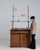 Here is a bar cabinet/etagere, its dark oak, glass shelves, cabinet base the first thing to catch the eye. Originating in...
