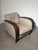 Elegant vintage Art Deco lounge chair by Bench, featuring beautifully curved dark wooden armrests and a refined beige...