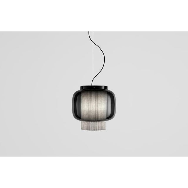 Manila t gr by sebastian herkner an incredibly elegant combination of artisanal blown glass and a plissé textile diffuser....