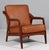 H. Brockmann Petersen lounge chair with frame of solid teak. New upholstered with vintage tan aniline leather. This piece...