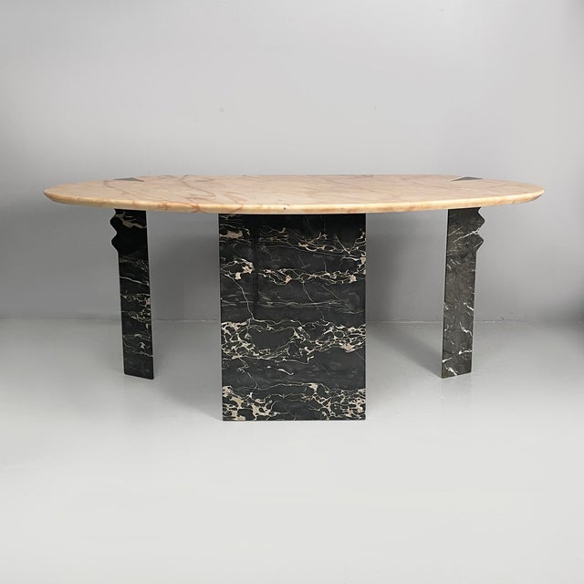 Italian modern wall console in black and pink marble, 1980s Wall console table with oval pink marble top. The rectangular...