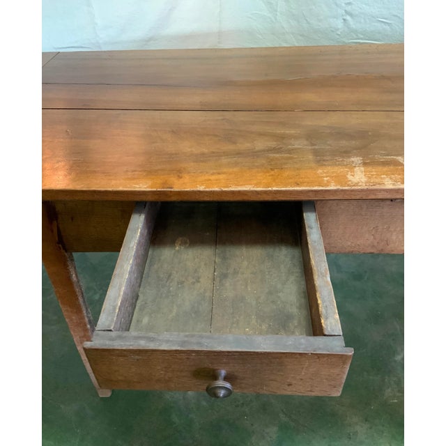 This French table / writing desk has two drawers for ample storage. It is substantial, has a rich patina and is finished...