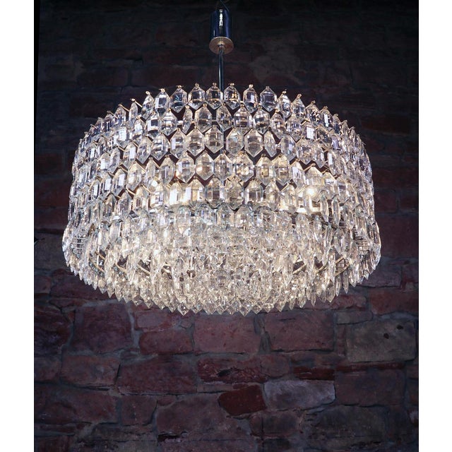 Spectacular huge cluster with numerous faceted crystals arranged in six rows on a silver-plated frame. The chandelier...