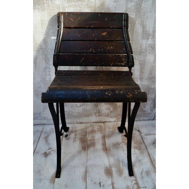 This antique tram seat, made from pine and a steel frame, with pine slats to the backrest and seat, the backrest pivots...