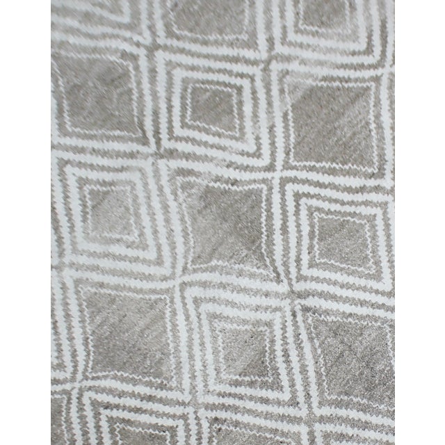A beautiful handmade environmentally friendly Bamboo silk rug, with a geometric design is made of 75% bamboo silk and 25%...