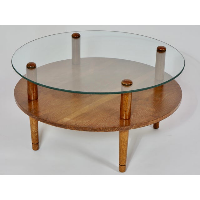 Mid Century Modern Round Double Tier Glass Walnut Coffee Table in the Style of Gilbert Rohde. Ready for the dining room or...