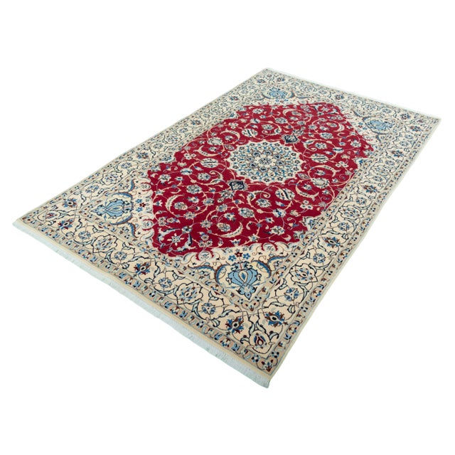 An exquisite hand-knotted Nain 9 La oriental rug with silk measuring 267 x 167 cm. The magnificent medallion design in...