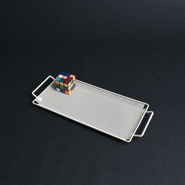 This white metal tray was designed by Mathieu Matégot in the 1950s. The metalwork displays the hallmarks of Matégot’s...