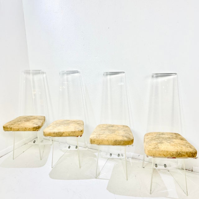 Sleek, sculptural, and quietly dramatic—this set of four high back Lucite dining chairs makes a strong case for clear...