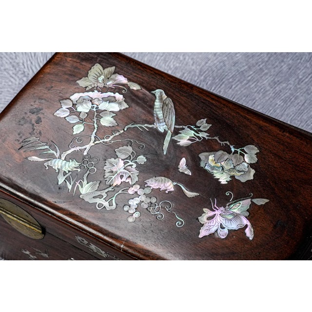 This fine 19th-century Chinese hardwood box is beautifully decorated with mother-of-pearl inlays on all sides, showcasing...