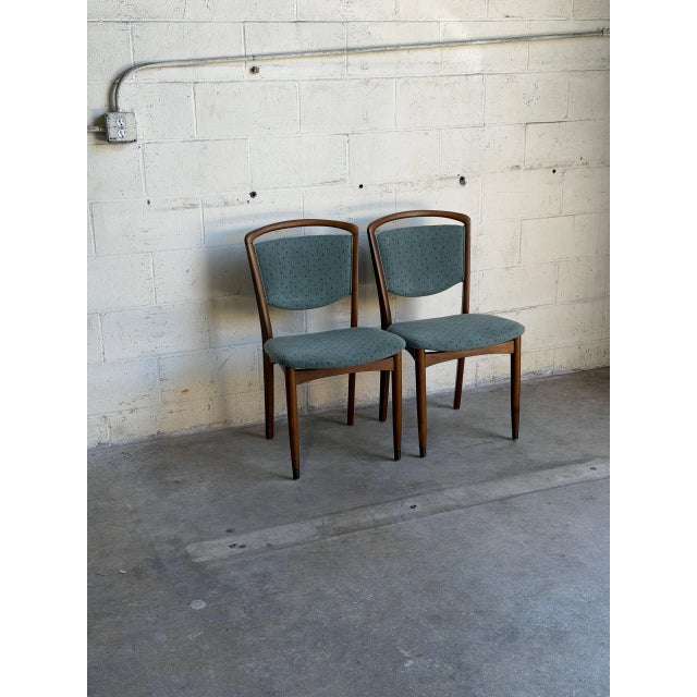 Beautiful vintage set of 2 Danish Mid-Century Modern dining chairs crafted in teak with elegant curved backrests and...