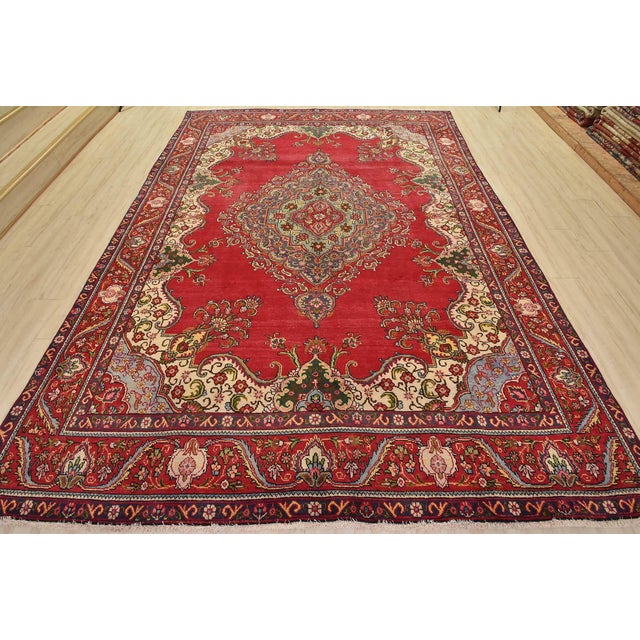 An authentic vintage traditional Tabriz rug hand-knotted with fine wool and natural dyes. This oriental rug features a...