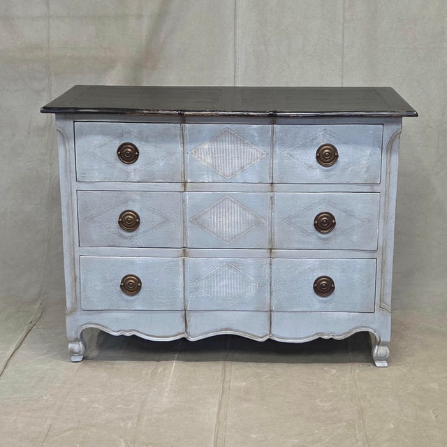 A charming vintage chest of drawers in the Swedish Rococo style with distressed blue gray paint and a black top. Large...