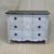 A charming vintage chest of drawers in the Swedish Rococo style with distressed blue gray paint and a black top. Large...