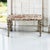 A richly veined French rouge marble top rests on the brass frame of this mid-century neoclassical coffee table. Four...
