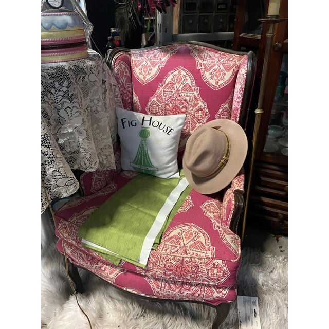 Up for consideration is a beautiful pink cushioned chair with wooden accents. This would look lovely in your home and it...