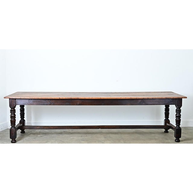 Here, we have a sprawling French table made from applewood, ash, and oak in the early 20th Century. The top consists of 5...