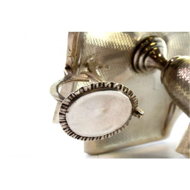 Guilloche Silver Paddle with Monogram Card and Flame Arrestor, in Very Good conditions. Designed 1890 to 1919 This piece...