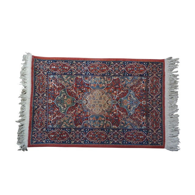 Vintage Belgian synthetic rug runner featuring a abstract floral medallion pattern in red, green, beige, and blue....