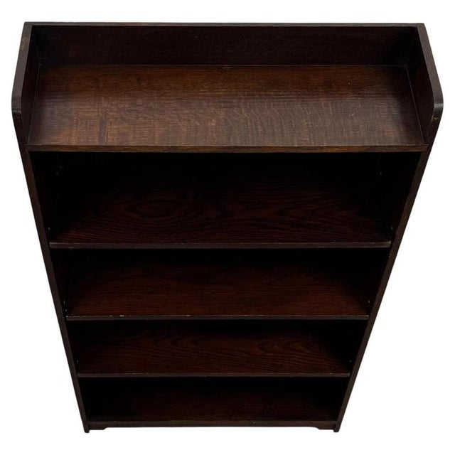 A charming early 20th-century English open bookcase, finely crafted from oak and distinguished by its exceptionally...