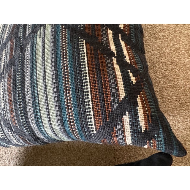 A beautiful pair of decorative throw pillows featuring a richly textured woven fabric and an intricate abstract geometric...