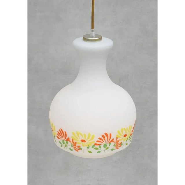 French opaline ceiling light from 70s France. Charming flower frieze adorns the satin finish opaline glass, giving off a...