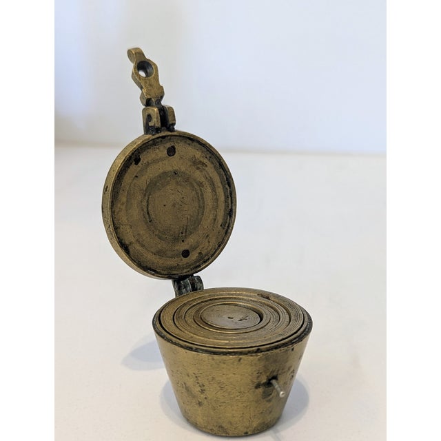 Antique brass nesting weight set with hinged lid and graduated internal discs. Approx. 3" tall. Excellent antique...
