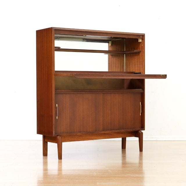 This vintage mid-century liquor Cabinet was produced in England by Beaver & Tapley during 1960s. Made from afromosia and...