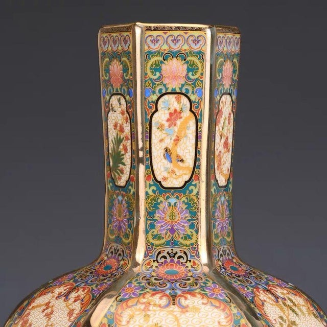 This beautiful vase features a classic six-sided (hexagonal) form with a tall, faceted neck and a rounded, bulbous body....