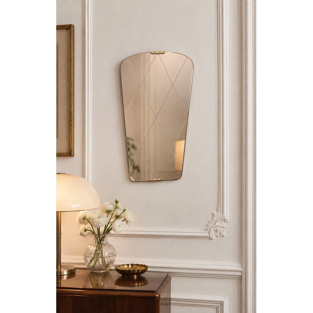 This free-form, engraved mirror from the 1960s captivates with its slender lines and organic silhouette, characteristic of...
