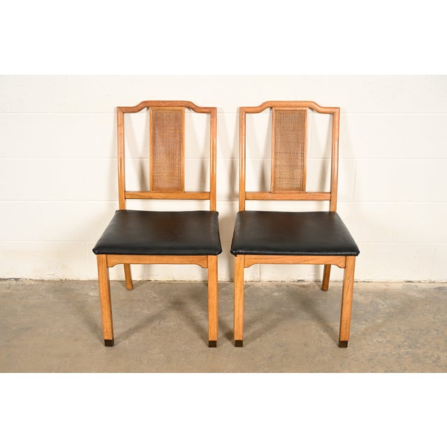 A gorgeous pair of Mid-Century Modern Hollywood Regency Chinoiserie side chairs or dining chairs In the manner of Henredon...