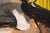 The painting depicts a stylish woman in a dramatic black dress, exuding confidence as she takes a drag from her cigarette,...