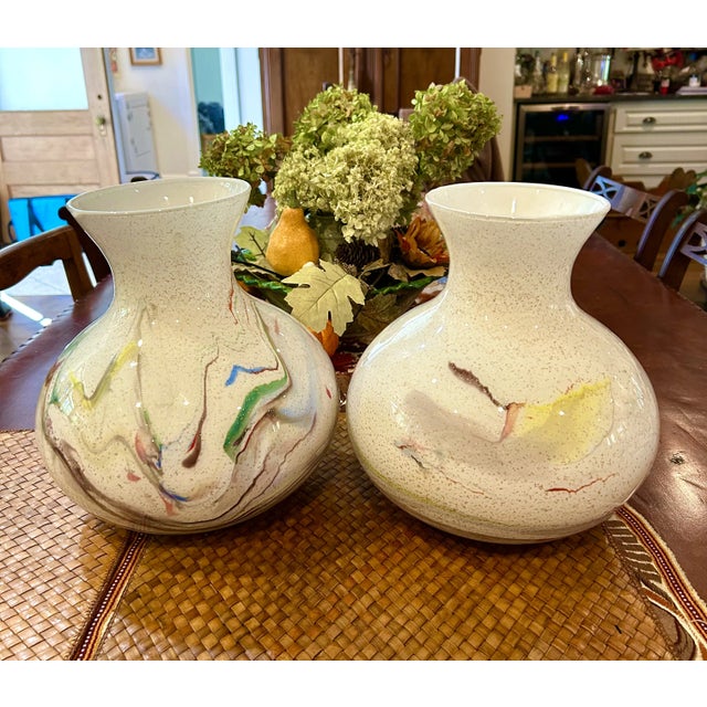 Offering a pair of blown glass vases from Italy with swirls of color and gold flecks. Perfect to display anywhere!