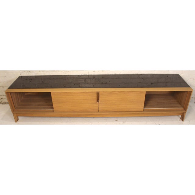 This is a stunning white oak and black laminate sideboard. This low profile piece combines sleek lines and a sturdy...