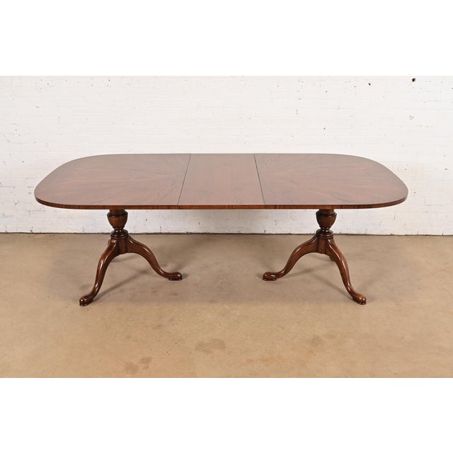 A gorgeous Georgian, Regency, or Queen Anne style double pedestal extension dining table By John Stuart USA, Circa 1970s...