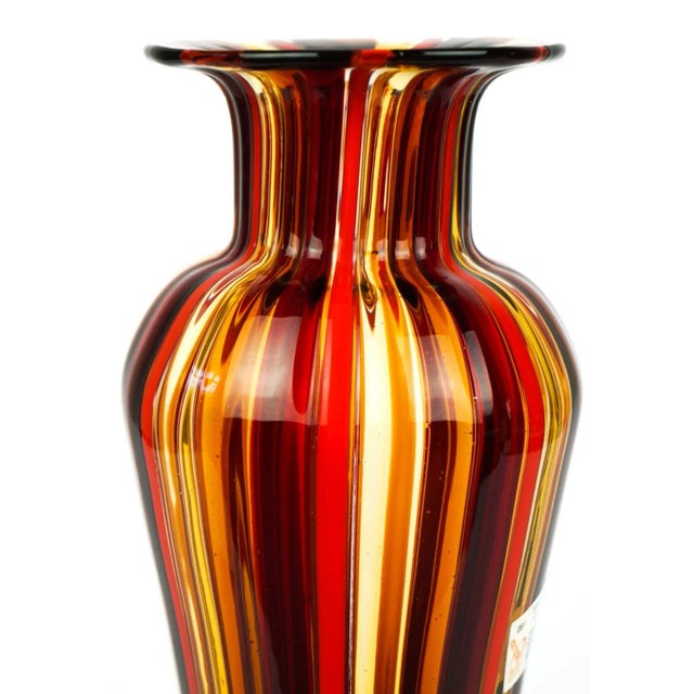 Vase in Murano blown glass with processing in Canna (chopsticks) red and amber glass. Entirely handmade and signed with...