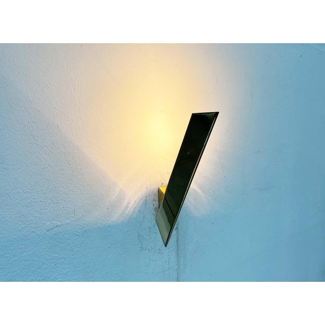 Two impressive brass wall lights by Kalmar. A simple design with a distinctive materiality. The light consists of a simple...