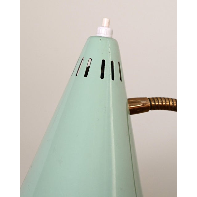 Painted metal clamp frame with a flexible brass neck and a conical painted metal diffuser. Scandinavian production, 1950s....