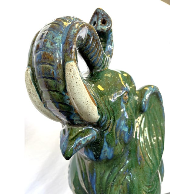 Striking large elephant statue from the 1970's. The Hollywood Regency style piece is made of ceramic with an awesome green...
