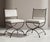 Elevate your outdoor oasis or sunroom with this striking pair of vintage cast iron patio chairs, masterfully crafted in...